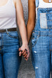 © santypan - Close up of women holding hands