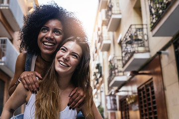 Wall Mural - Beautiful women having fun in the street.