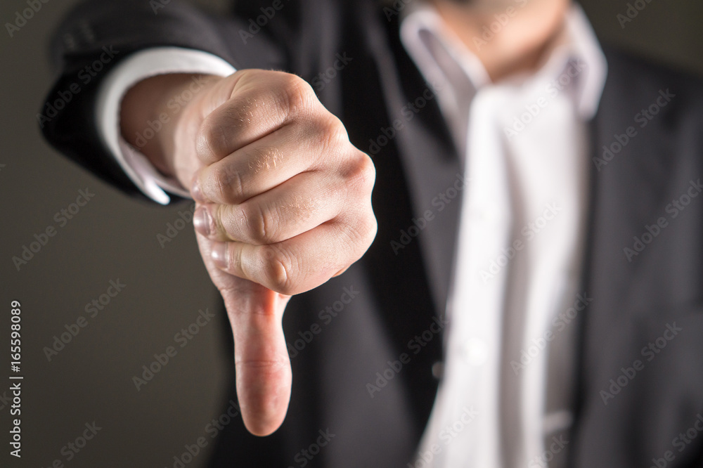 Business man showing thumbs down.