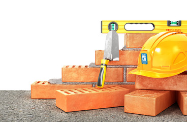 Wall Mural - Construction concept. Part of brick wall in construction process with construction tools . 3d illustration