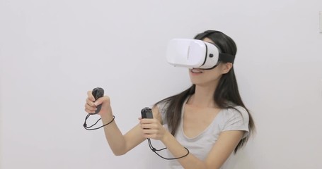 Wall Mural - Woman playing game with VR device