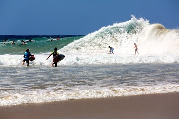 Surfers on a backwash wave at Snapper Rocks on the Gold Coast of Queensland Australia.