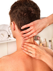 Shoulder and neck massage for man in spa salon. Doctor making neck therapy in rehabilitation center. Repositioning of joint in clinic. Correction of dislocation of neck by experienced specialist.