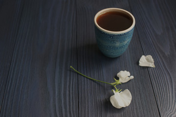 Poster - A cup of black coffee and a flower of sweet pea