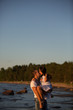 © viktoria_koks - A young couple in love, on the shore of the Bay at sunset