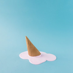Wall Mural - Overhead pink ice cream on pastel blue background. Minimalistic summer food concept.
