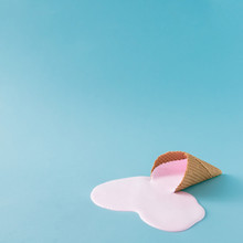 Pink Ice Cream Spilled On Pastel Blue Background. Minimalistic Summer Food Concept.