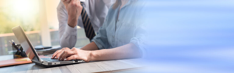 Wall Mural - Businesswoman using a laptop, light effect