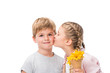 © LIGHTFIELD STUDIOS - adorable little girl holding waffle cone with flowers and kissing cute boy isolated on white