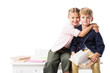 © LIGHTFIELD STUDIOS - adorable happy schoolkids hugging while studying together isolated on white