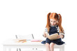© LIGHTFIELD STUDIOS - shocked red haired schoolgirl sitting on table and reading book isolated on white