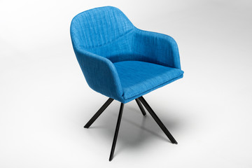 Wall Mural - Studio shot of stylish chair with blue fabric top and triangular metallic legs on white