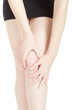 Young woman with black skirt suffering from knee pain isolated on white, clipping path