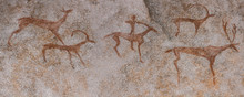 Drawings In A Cave On The Wall, Painted With Ocher Rock. Primitive Man, Primitive Neanderthal. The Hunter Hunts A Deer. Stone Age, Ice Age. Caveman.