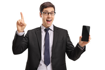 Canvas Print - Businessman holding a phone and pointing up