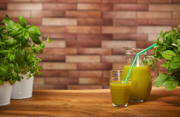 Wall Mural - Fresh organic green smoothie with spinach, cucumber, parsley, celery on wooden background