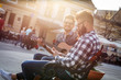 © BalanceFormCreative - Group of people hangout at the city street.They sitting on bench ,singing and playing guitar.