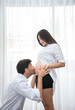 © DJ Creative Studio - Happy Family with Asian Husband Kiss on the Belly of His Wife Meaning to Take Care with Love in the Room - Family Concept