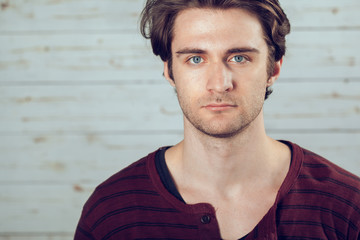 Portrait of a handsome man on old wooden background