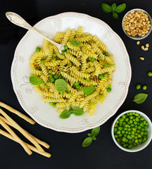 Wall Mural - Fusilli pasta with young peas, parmesan and basil.