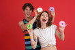 © Drobot Dean - Young cheerful two friends standing with donuts
