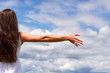 © Sviatoslav Kovtun - Freedom feel good and travel adventure, religion concept. Woman rising hands on blue sky and white cloud.