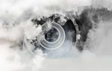 Wall Mural - Drag racing car burns rubber off its tires in preparation for the race