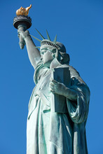 Statue Of Liberty Detail In A Sunny Day, Clear Blue Sky In New York
