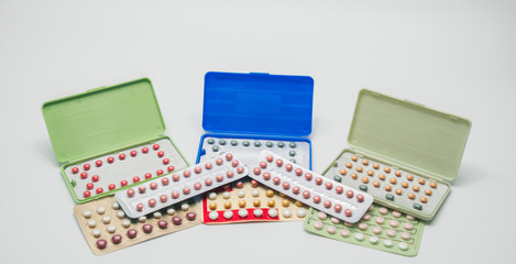 Wall Mural - Birth control pills with modern packaging on white background