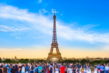 Paris Tourist Place / Colorful Large Group Of Unrecognizable People Blurred In Front Of Paris Eiffel Tower At Evening Light (copy Space)