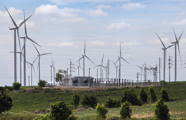 Wall Mural - wind turbines generating electricity with high voltage electrical power substation for renewable win