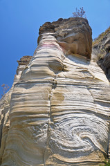 Wall Mural - A rock of unusual shape against the blue sky