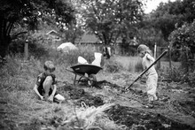 Young Boy And Girl Outdoors, Working In Garden , Black And White