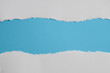 © Nattapol_Sritongcom - white torn paper with blue background, ready for design