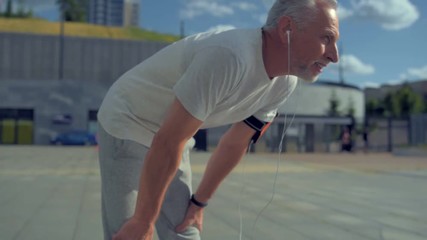 Wall Mural - Active aged man enjoying running in the city