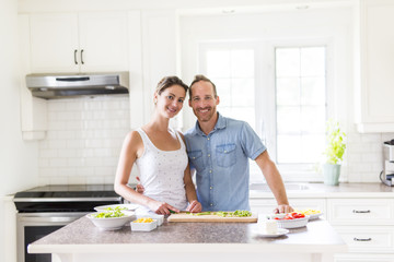 couple in the kitchen doing salad together