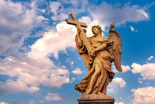 Marble Statue Of Angel With The Cross At Sunset, One Of The Ten Angels On Saint Angel Bridge, Symbols Of Christ's Passion, Rome, Italy
