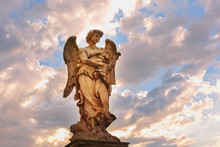 Marble Statue Of Angel With The Whips At Sunset, One Of The Ten Angels On Saint Angel Bridge, Symbols Of Christ's Passion, Rome, Italy