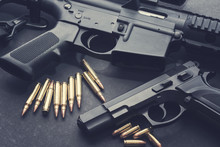 Handgun With Rifle And Ammunition On Dark Background
