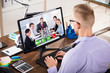 © Andrey Popov - Businessman Video Conferencing On Computer