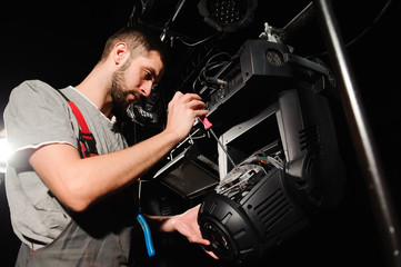 Sticker - The lighting engineer adjusts the lights on the stage.