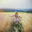 © sushytska - happy running girl on a wheat field in the sunlight