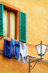 Sticker - Traditional house with clothesline and street lantern in Siena