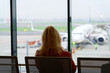 © Roman Babakin - Woman sitting and waiting for her flight at Milan airport