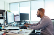 © Jacob Lund - Businessman working on computer at his desk in office.