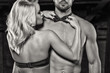 Sensual blonde woman straighten bow tie on naked sexy man black and white