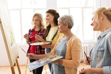 Canvas Print - women with easel and palettes at art school