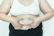 © chompoo - Fat overweight woman pinching her fat.