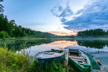 Two Fishing Boats On A Small Lake At Dawn
