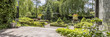 Leinwanddruck Bild - Green garden with concrete paths